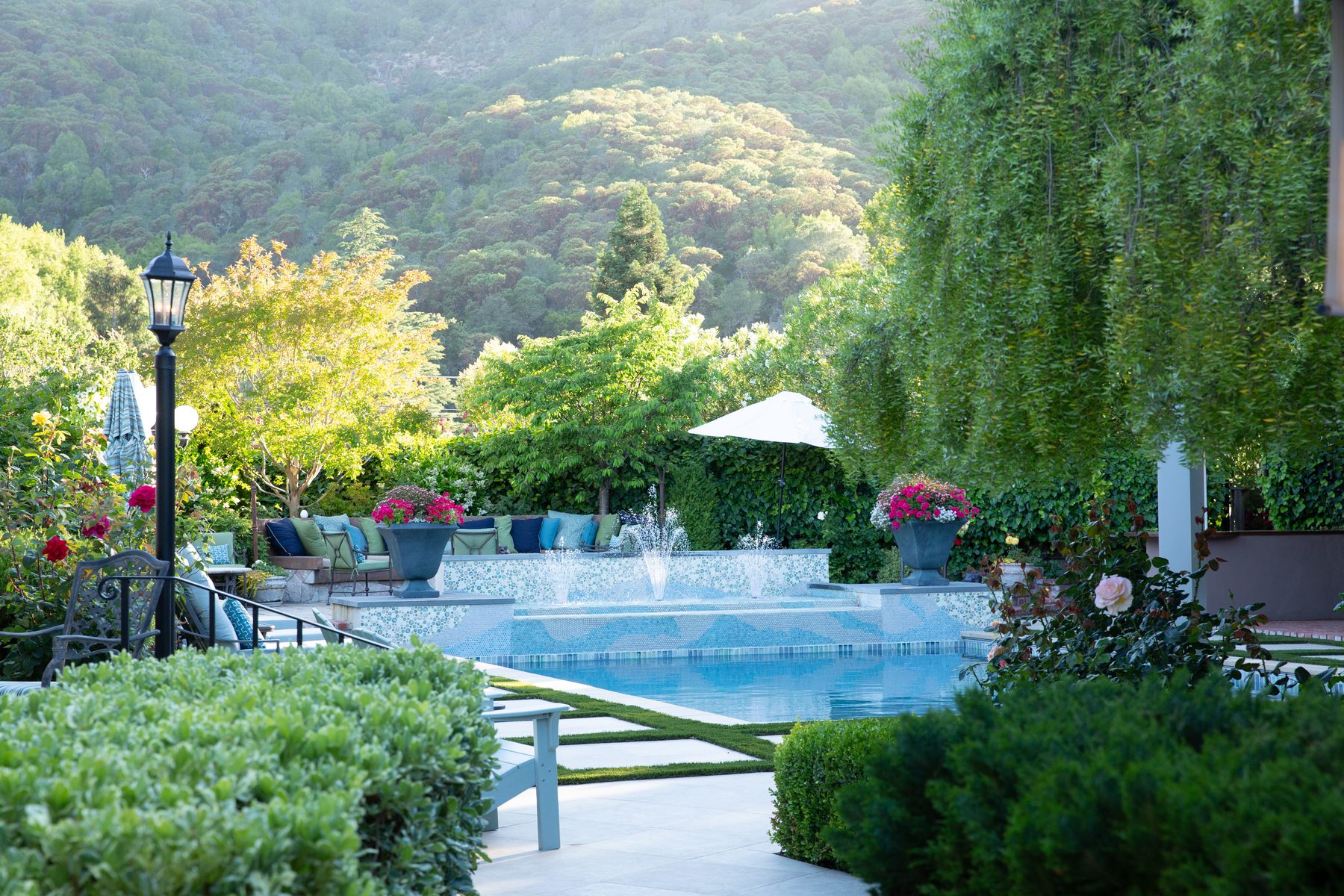 Pool terrace with planting beds and the hills beyond
