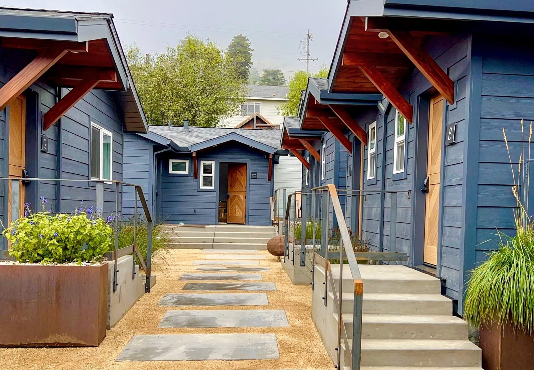 Concrete stepping path and grasses at the entrance to Surf Lodge